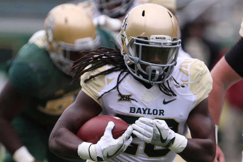 Baylor running back JaMycal Hasty (20) runs upfield during the first half of the NCAA...