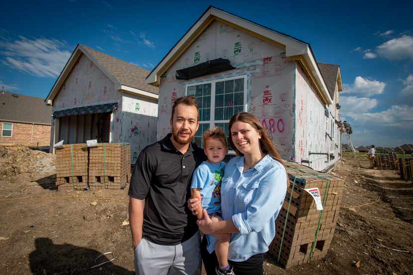 The Brace family, James, Lucas (center) and Samantha, stand outside their new home in Fort...