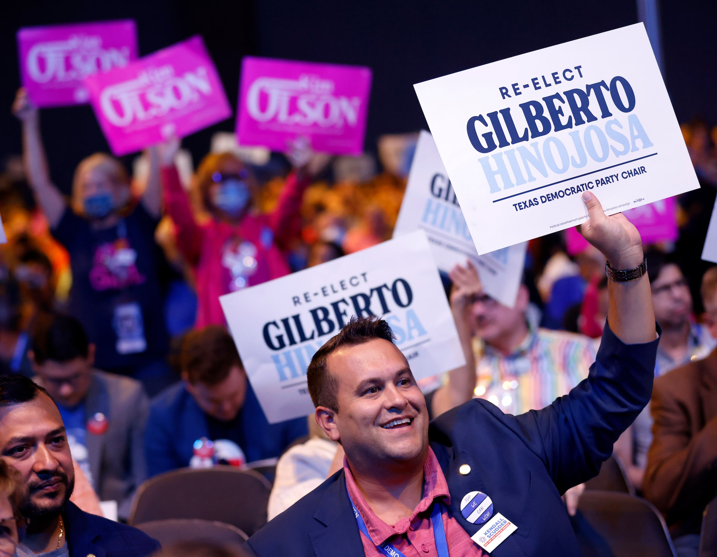 Supporters of incumbent Gilberto Hinojosa and challenger Kim Olson cheer their support...