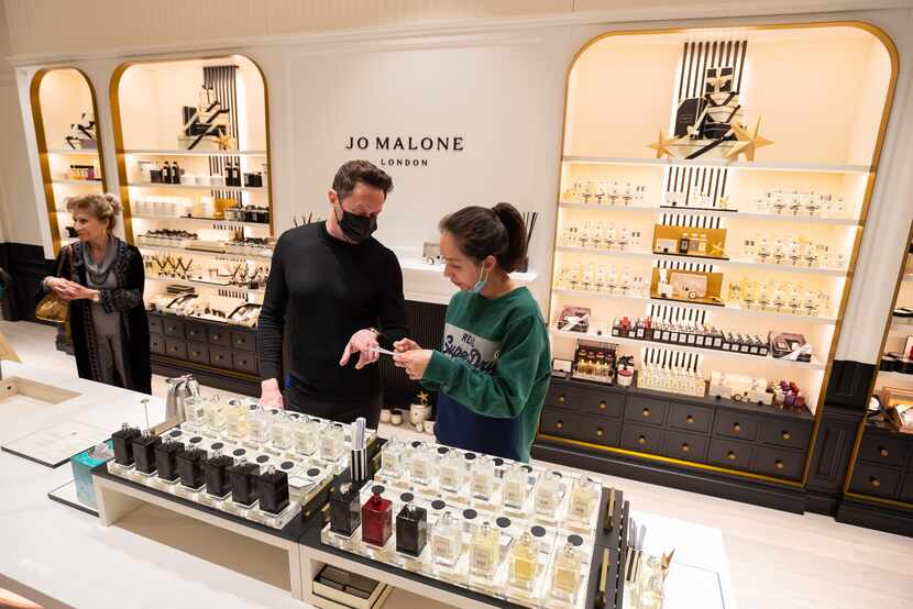 Employee Chad Spurrier helps shopper Jessica Pham at the Jo Malone London store at NorthPark...