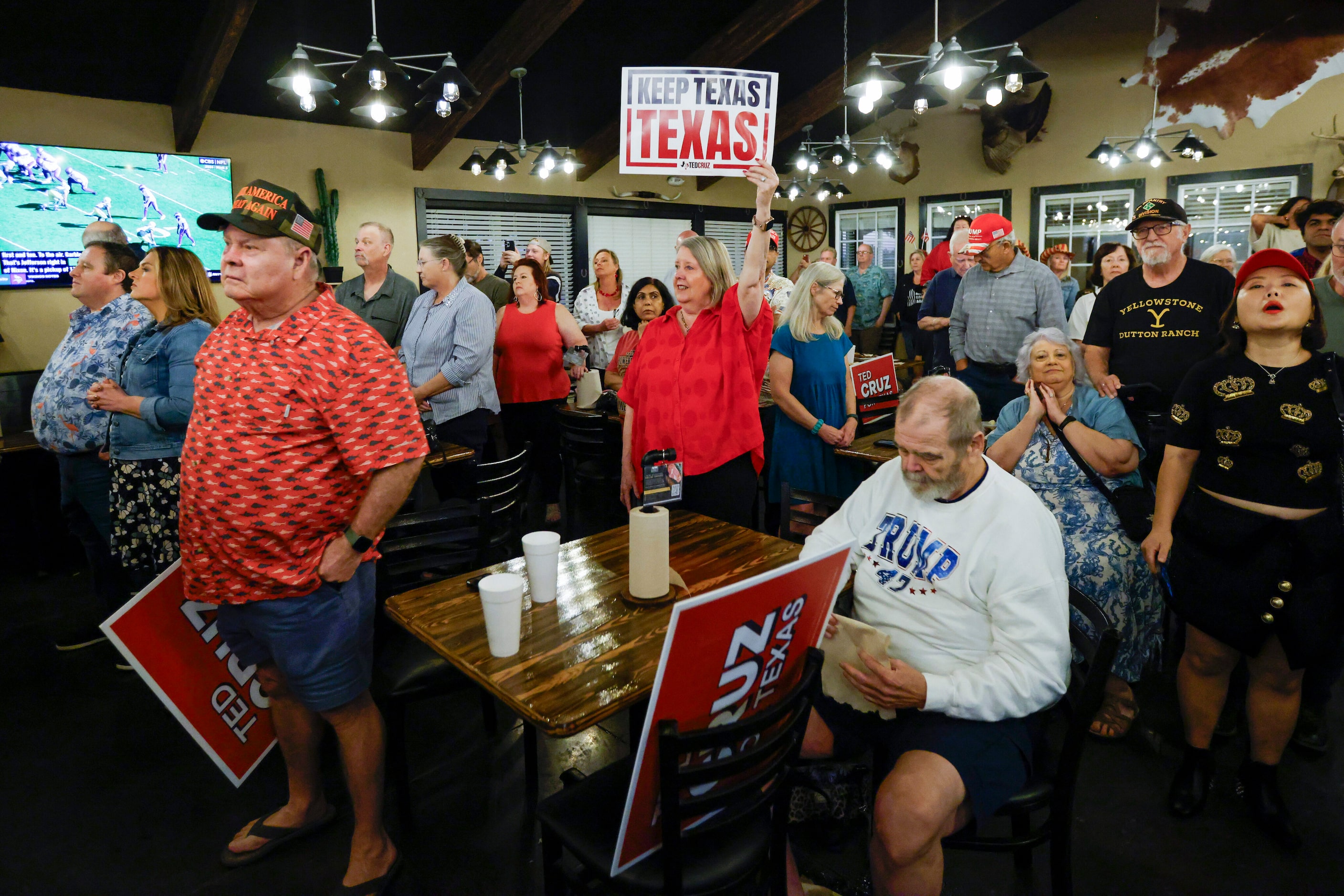 People watch a campaign rally for Senator Ted Cruz (R-Texas) at Outpost 36 BBQ, Saturday,...