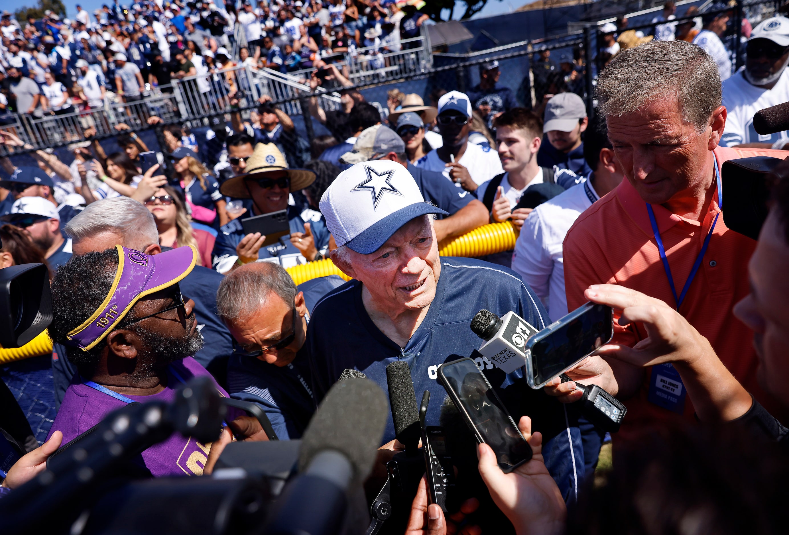 Surrounded by fans and media, Dallas Cowboys owner Jerry Jones answers questions about Dak...