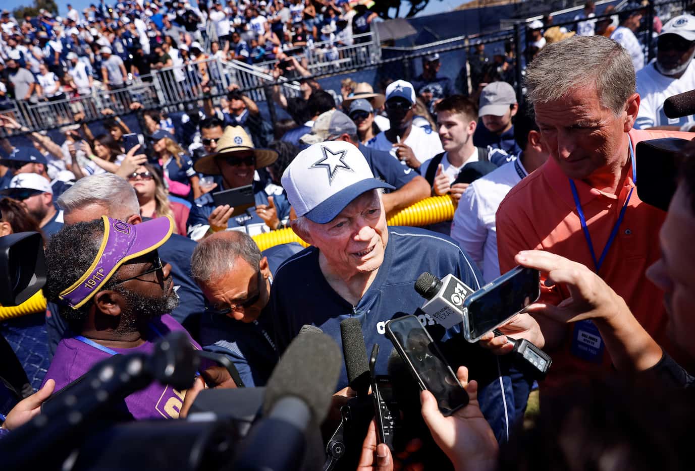 Surrounded by fans and media, Dallas Cowboys owner Jerry Jones answers questions about Dak...