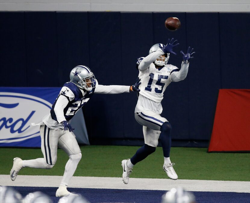 Dallas Cowboys wide receiver Devin Smith (15) catches a pass in front of Dallas Cowboys...