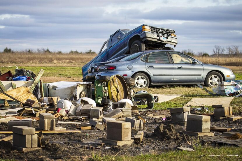 Cars are stacked up amid rubble  in Blue Ridge. Neighbors in the area rushed to help the...