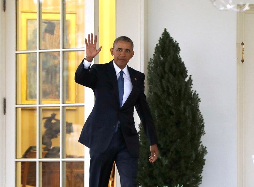 President Barack Obama waves as he leaves the Oval Office of the White House in Washington,...