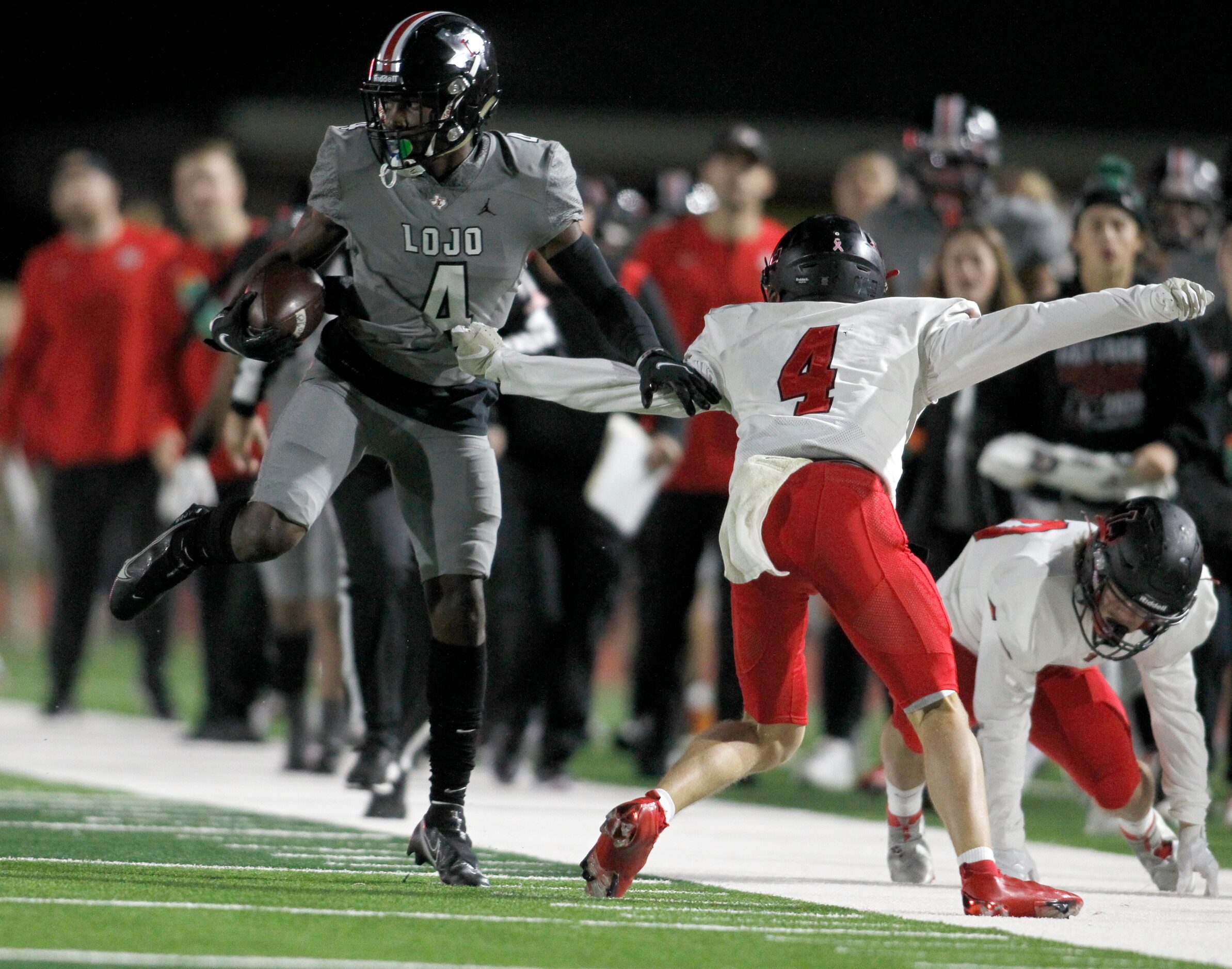 Lucas Lovejoy receiver Kyle Parker (4), left, tries to avoid the arm-tackle attempt by...