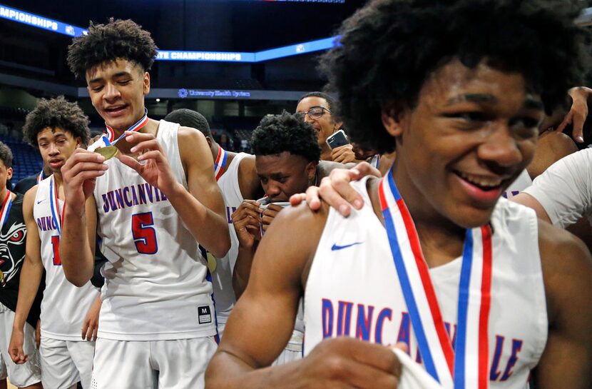 Duncanville's Micah Peavy #5 checks out his medal while Duncanville's Ja'Bryant Hill #2...