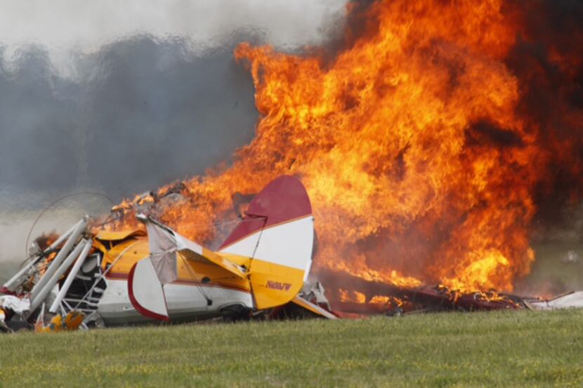 Flames erupted from a plane after it crashed at the Vectren Air Show at Dayton International...
