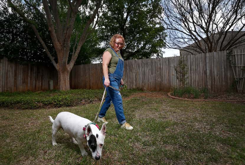 Kelli Bennett walks Simmy, a client's dog, on Wednesday, March 22, 2017, in Flower Mound,...
