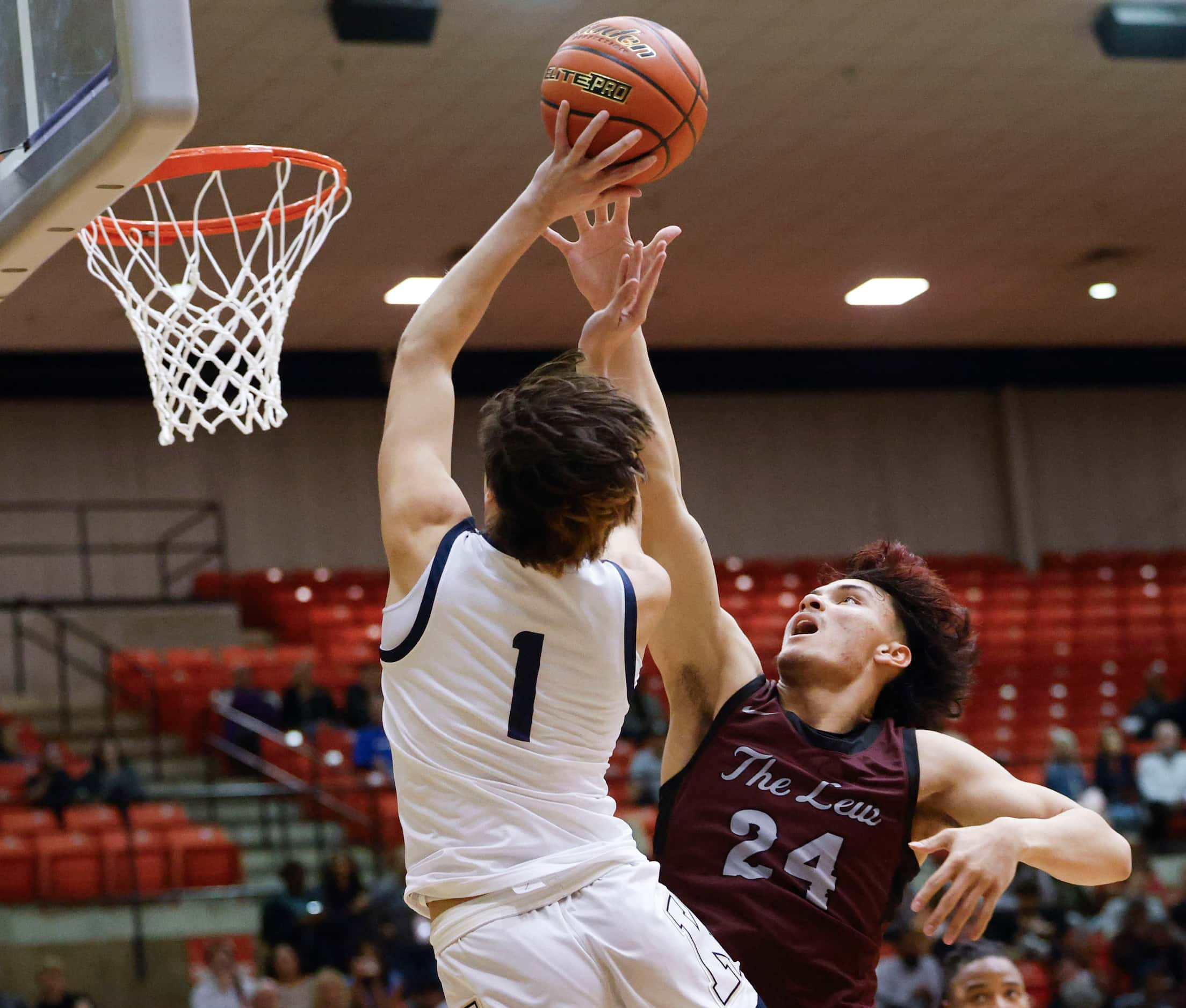 Keller high’s Luke Fabian (left) shoots as Lewisville High’s Aj Mcpeters reaches to block...