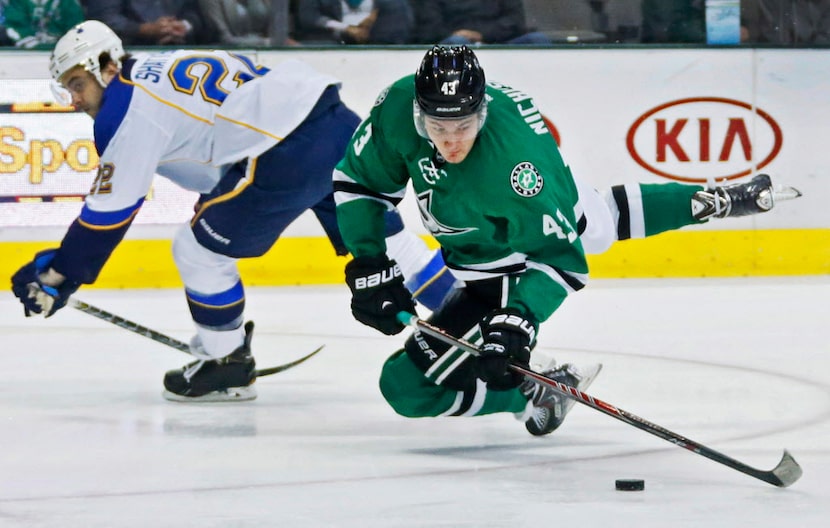 Dallas' Valeri Nichushkin (43) is tripped up by St. Louis defender Kevin Shattenkirk (22),...