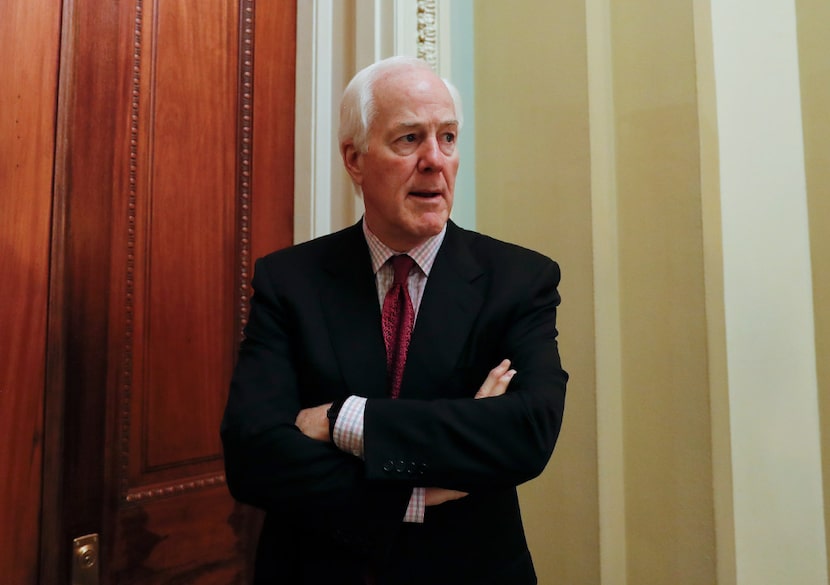 Senate Majority Whip John Cornyn of Texas, pauses as he speaks to reporters outside his...