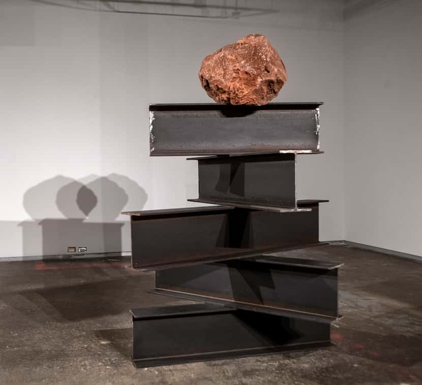 The 2019 work "Perpetuum Mobile" features a volcanic rock perched atop metal beams.
