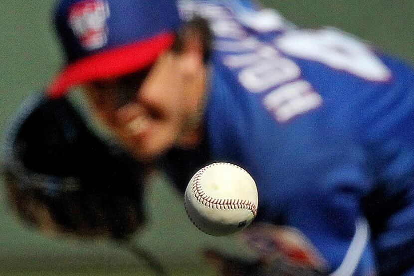 Texas starting pitcher Derek Holland throws a second inning pitch during the Texas Rangers...