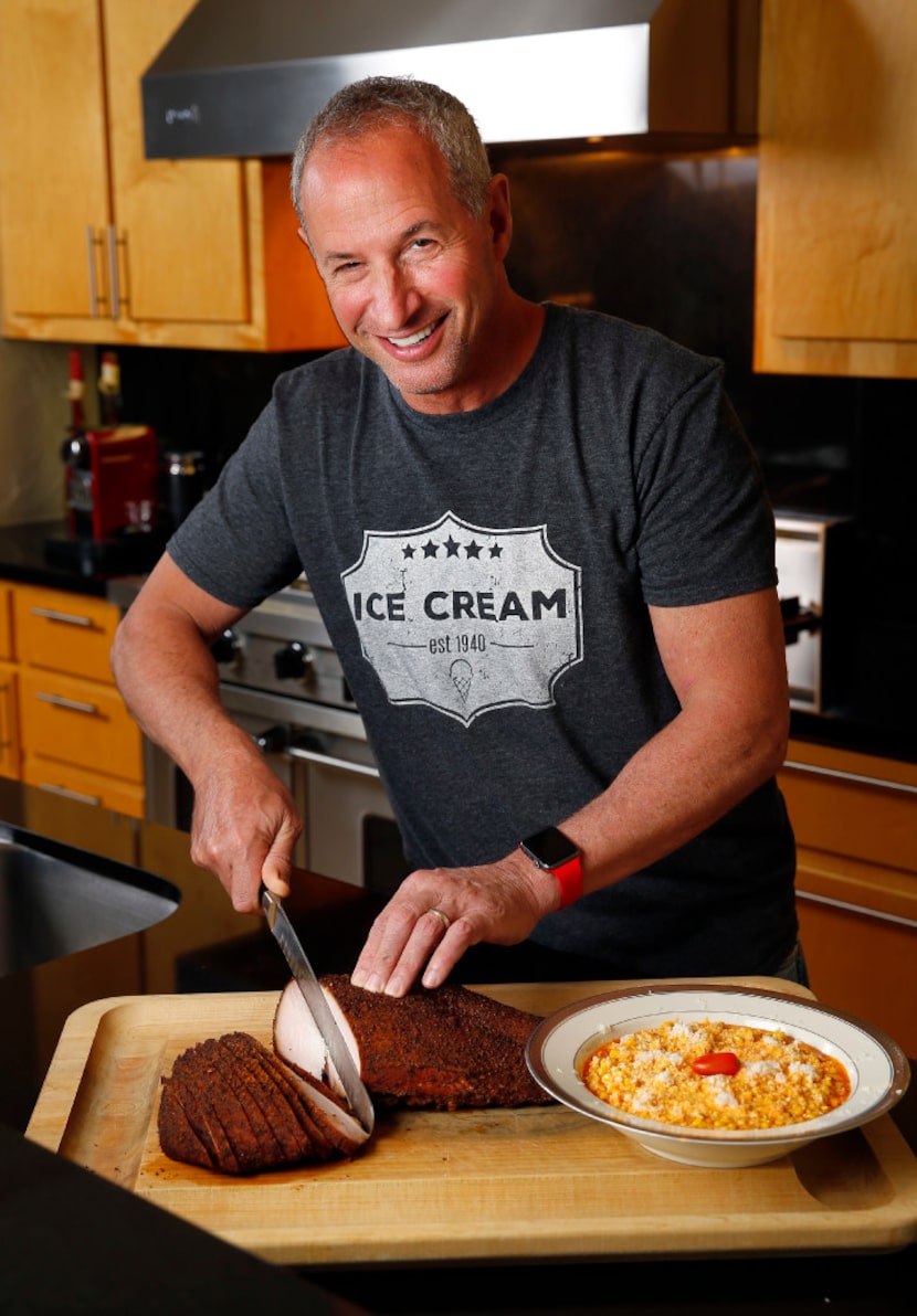 Cattleack Barbecue pitmaster Todd David displays his cheesy chipotle corn (right) and smoked...