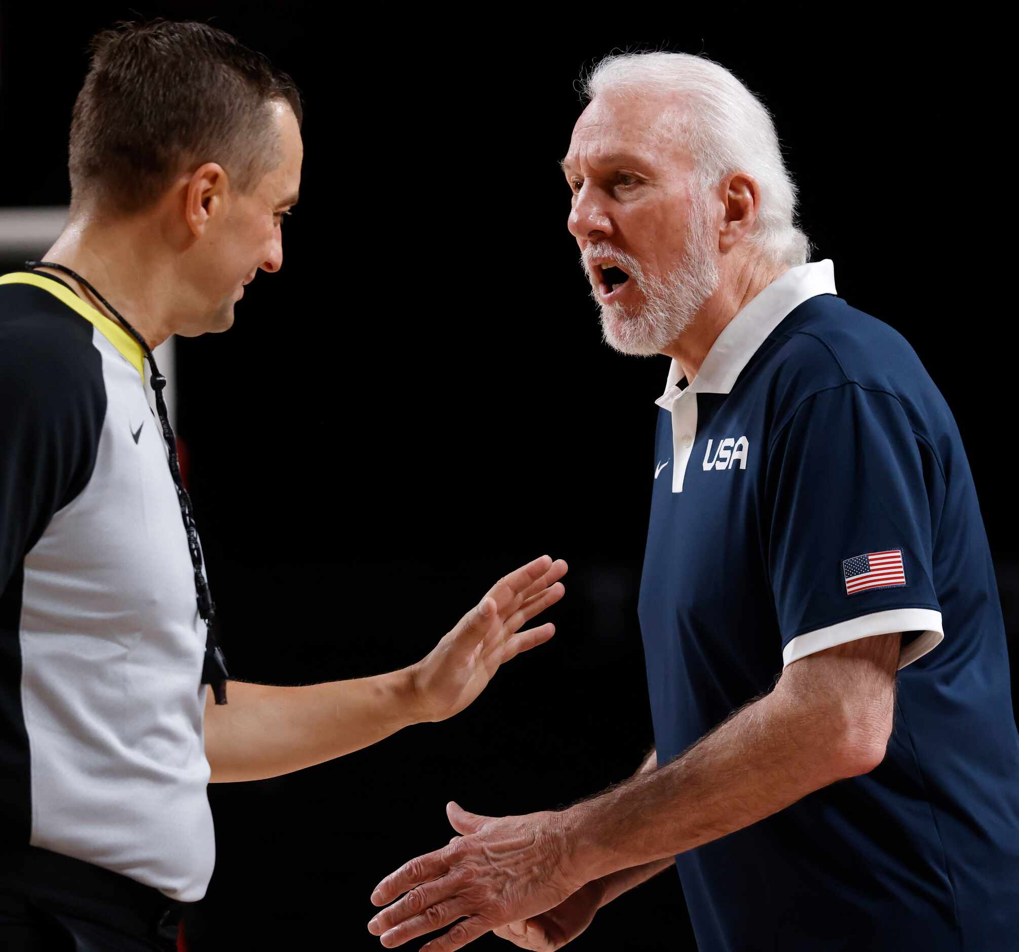 USA’s head coach Gregg Popovich talks to a referee about a call in a game against Australia...