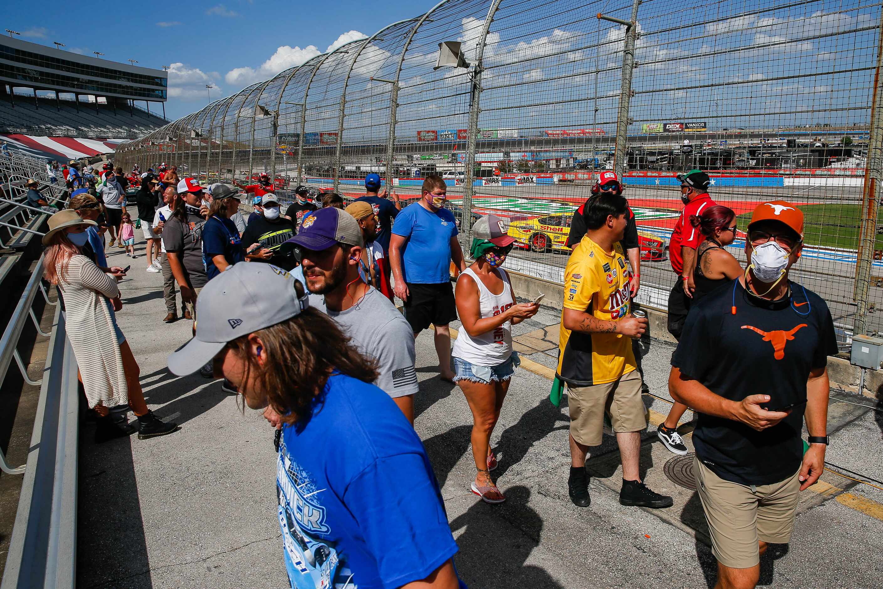 Fans gather to take photos of the stalled cars during the NASCAR Cup Series O'Reilly Auto...