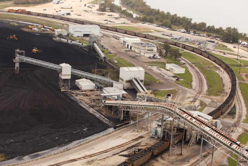 Coal is unloaded at the NRG power plant in 2016, where a carbon capture system will soon be...