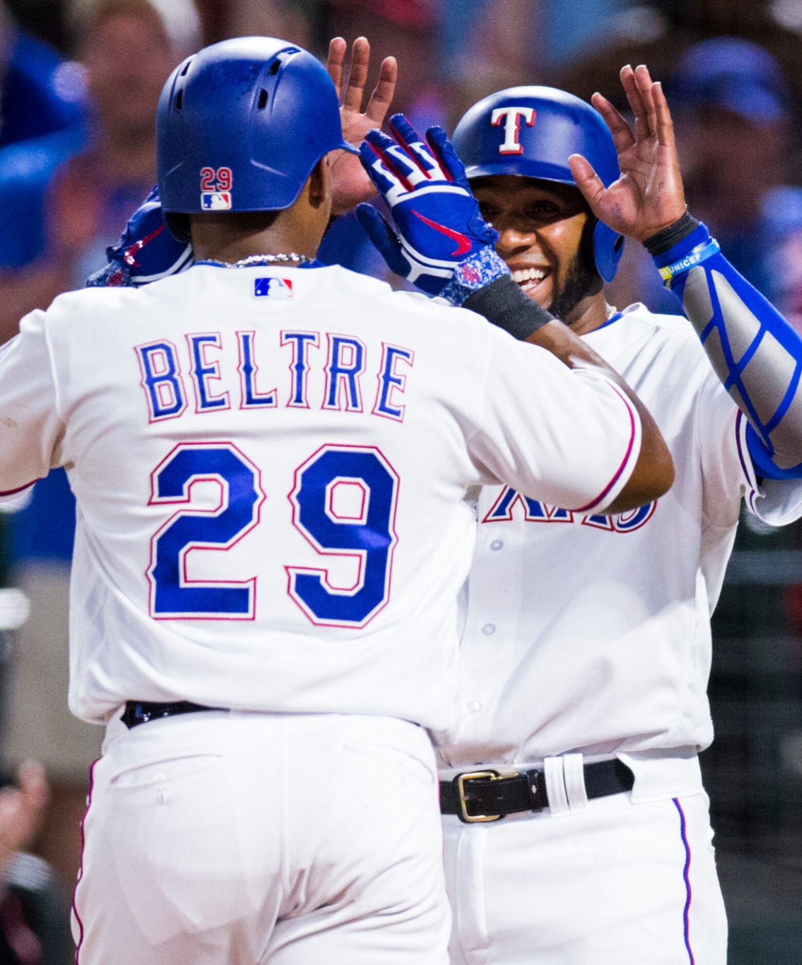 Texas Rangers third baseman Adrian Beltre (29) high-fives shortstop Elvis Andrus (1) after...