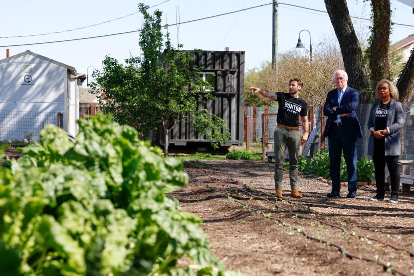 Bonton Farms staff Davidson Sutherland (left) points out as Senator John Cornyn (R-TX)...