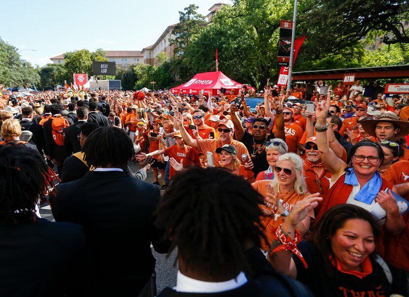 The Texas Longhorns greet fans as they make their way down Bevo Boulevard prior to a college...