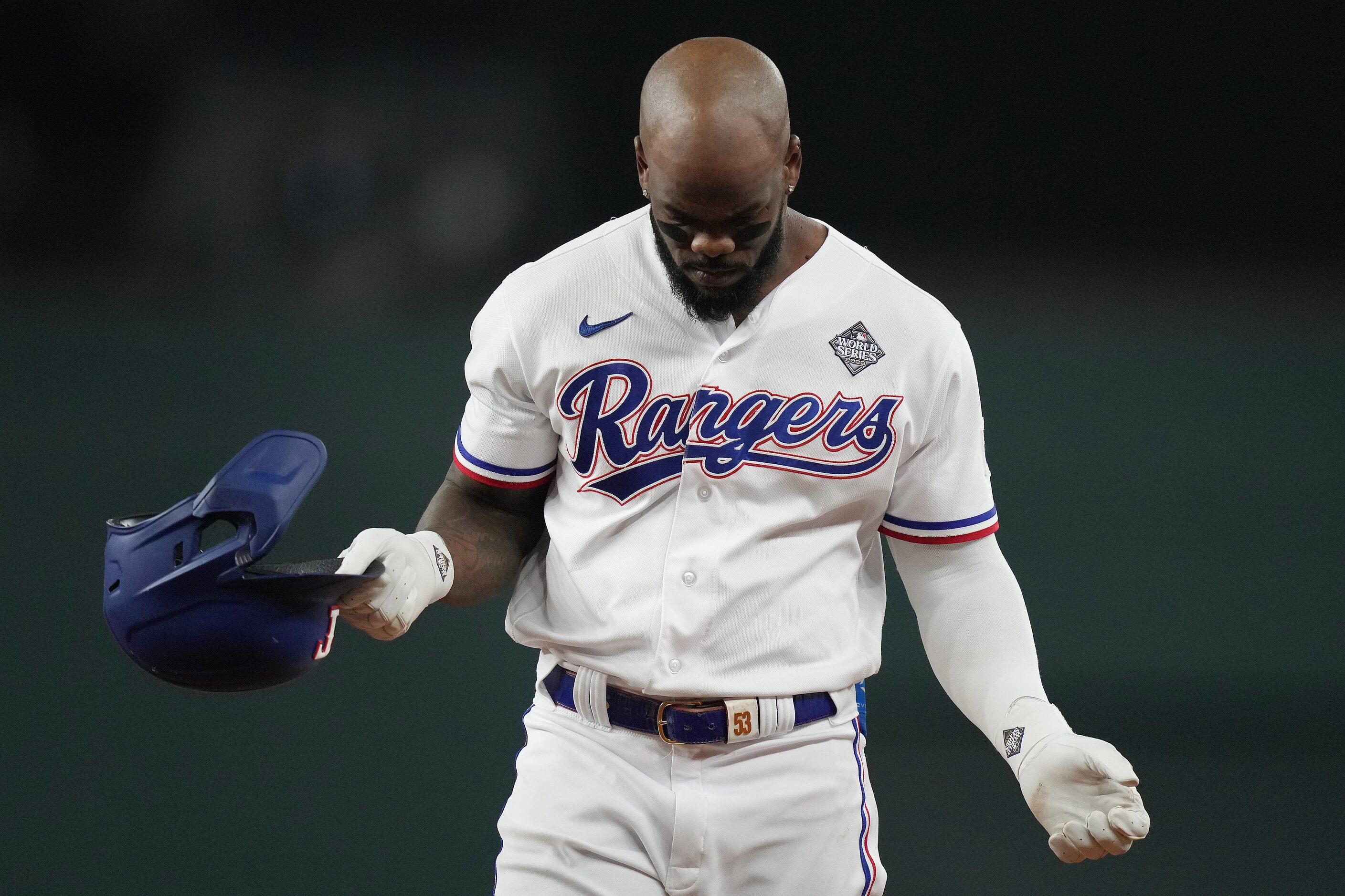 Texas Rangers' Adolis Garcia reacts after flying out to end the fourth inning in Game 2 of...