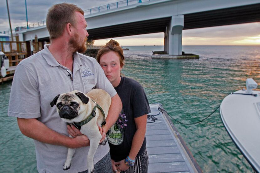 Tanner Broadwell holds his dog with Nikki Walsh at Madeira Beach, Fla., on Feb. 7.  The...