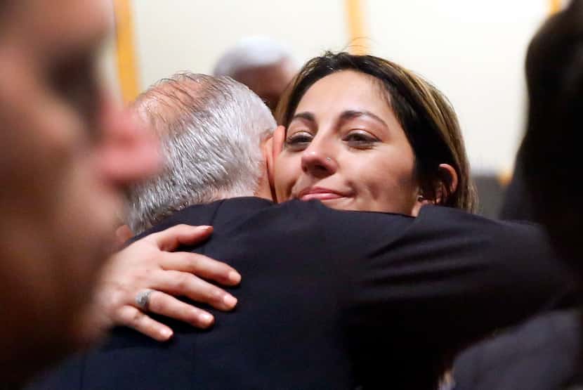 Nicole Sherrard, widow of slain Officer David Sherrard,  receives a hug from Richardson...