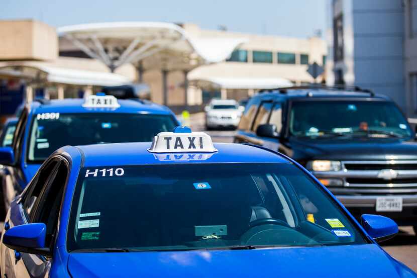 Taxi cabs wait for customers at Terminal A at DFW International Airport on Aug. 1, 2018.