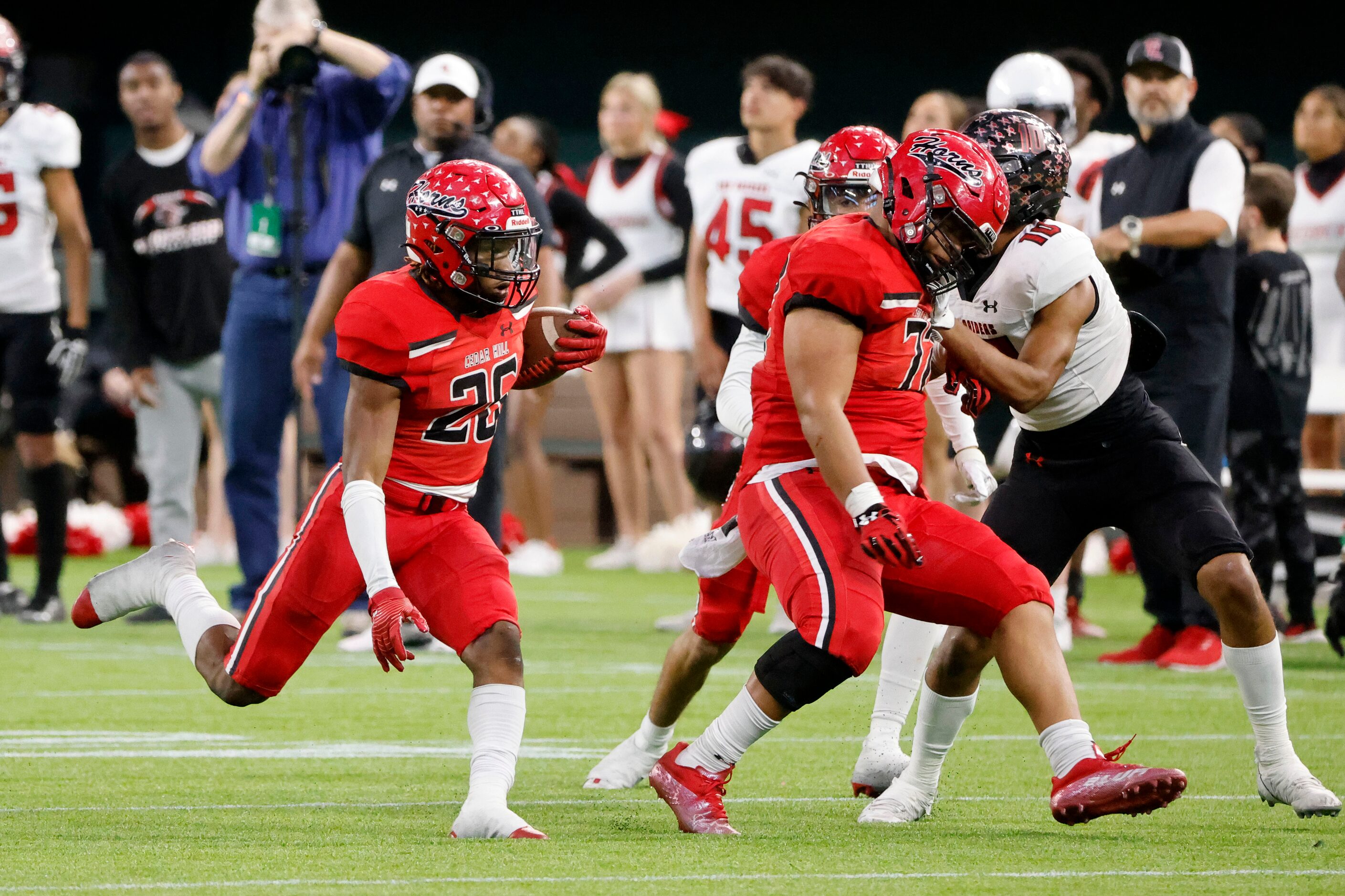 Cedar Hill running back Jaylon Jenkins (26) follows being the block of Josiah Jefferson (72)...