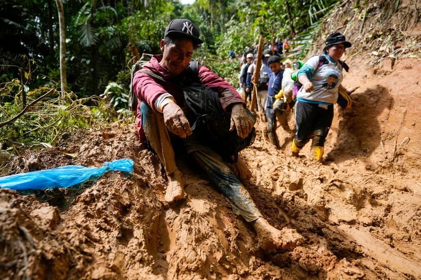 A Venezuelan migrant rests during the trek across the Darién Gap from Colombia to Panama in...