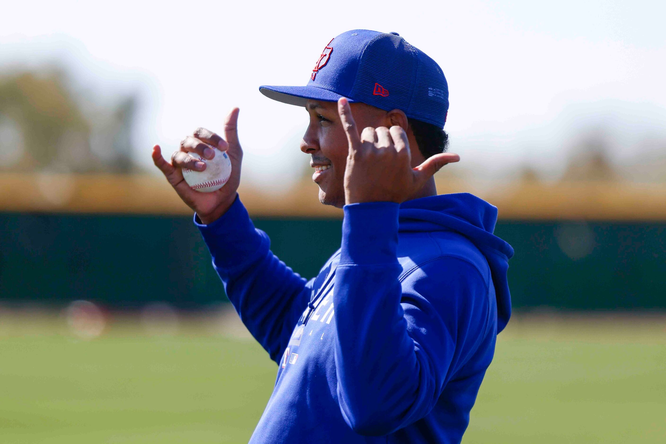 Texas Rangers right handed pitcher Jose Leclerc smiles as he stretches during a spring...