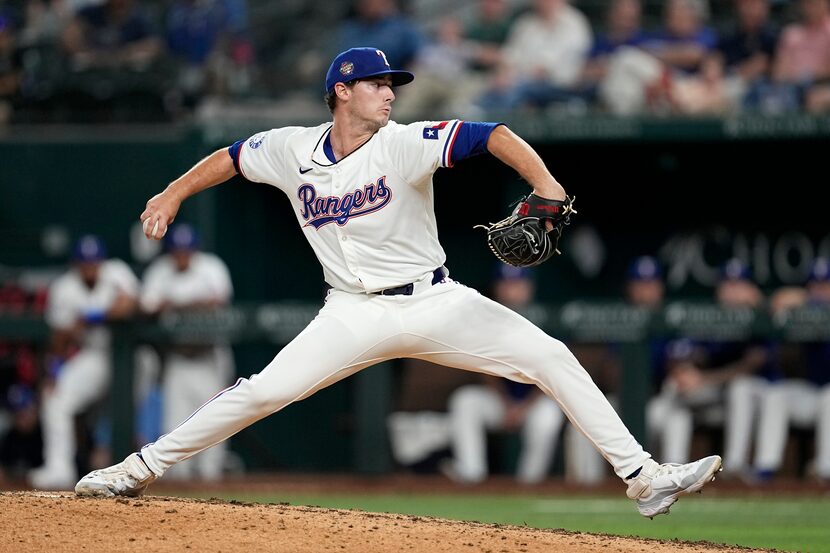 Texas Rangers' Cole Winn throws to the Washington Nationals in the ninth inning of a...