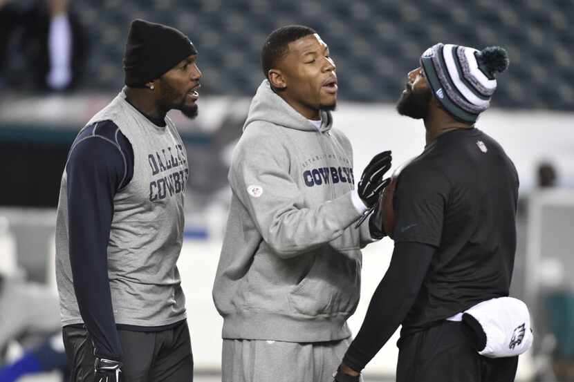 Dallas Cowboys wide receiver Terrance Williams, center, keeps the peace between wide...