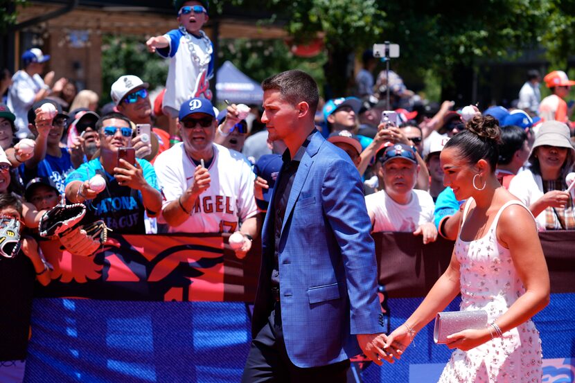 Texas Rangers shortstop Corey Seager, left, walks with his wife Madisyn during the baseball...