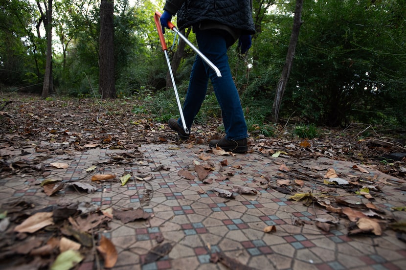 Dallas City council member Jaynie Schultz carries a pair of trash tongs as she walks over...