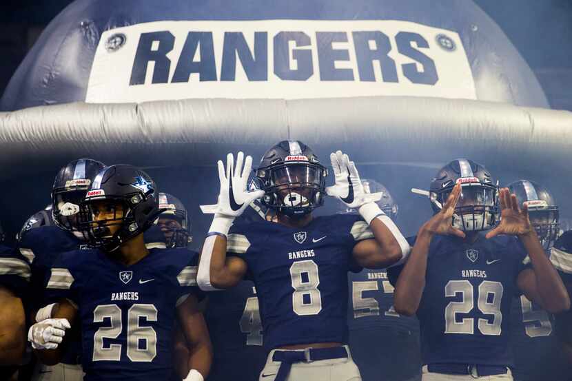 Frisco Lone Star football players prepare to run on the field before a District 5-5A...
