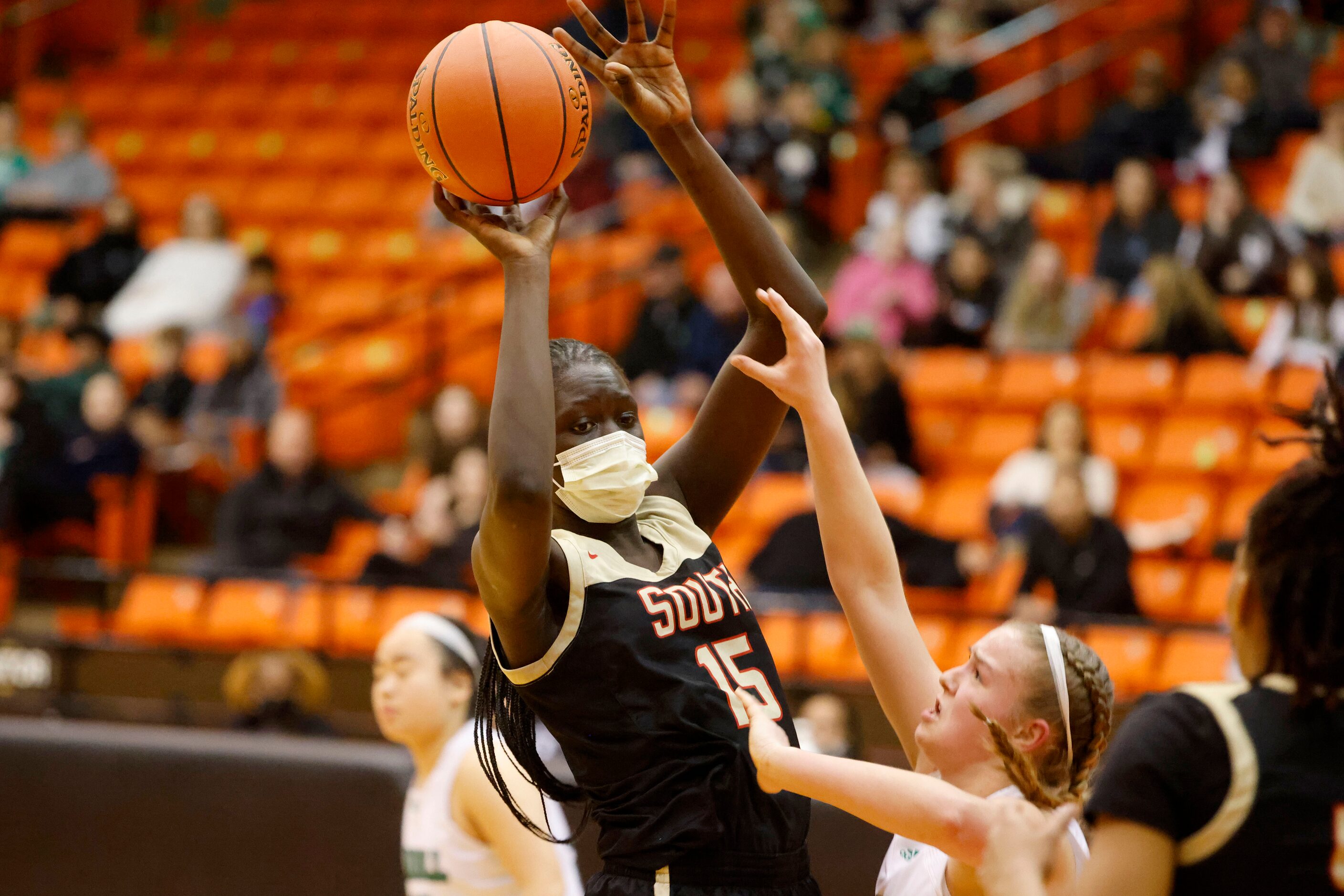 South Grand Prairie’s Adhel Tac (15) grabs a rebound in front of Southlake Carroll’s Taryn...