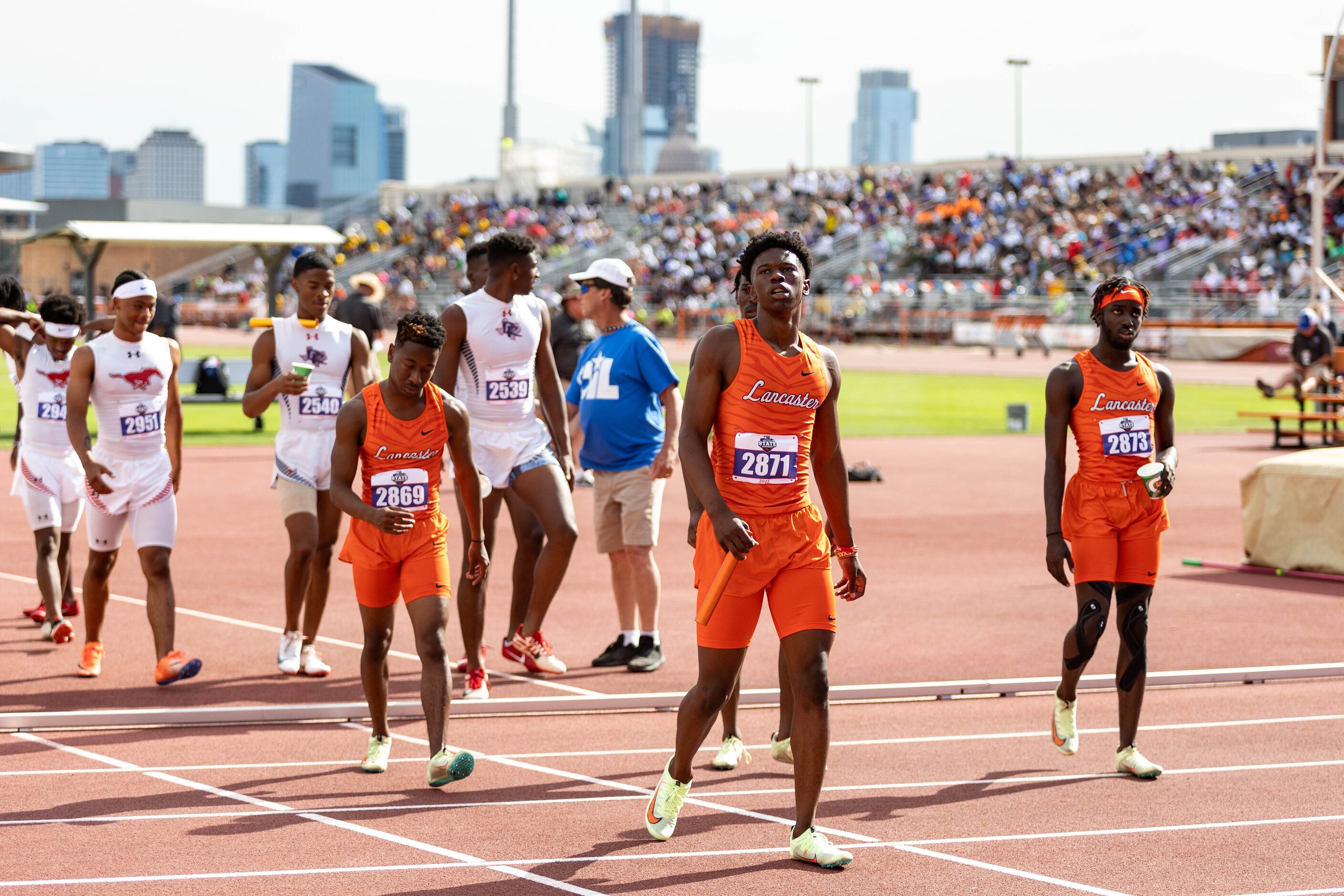 Corian Gipson of Lancaster, center, walks off the track after finishing third in the boys’...