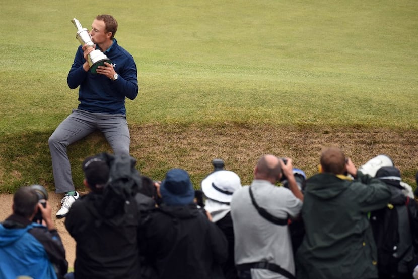 US golfer Jordan Spieth poses for pictures as he kisses the Claret Jug, the trophy for the...