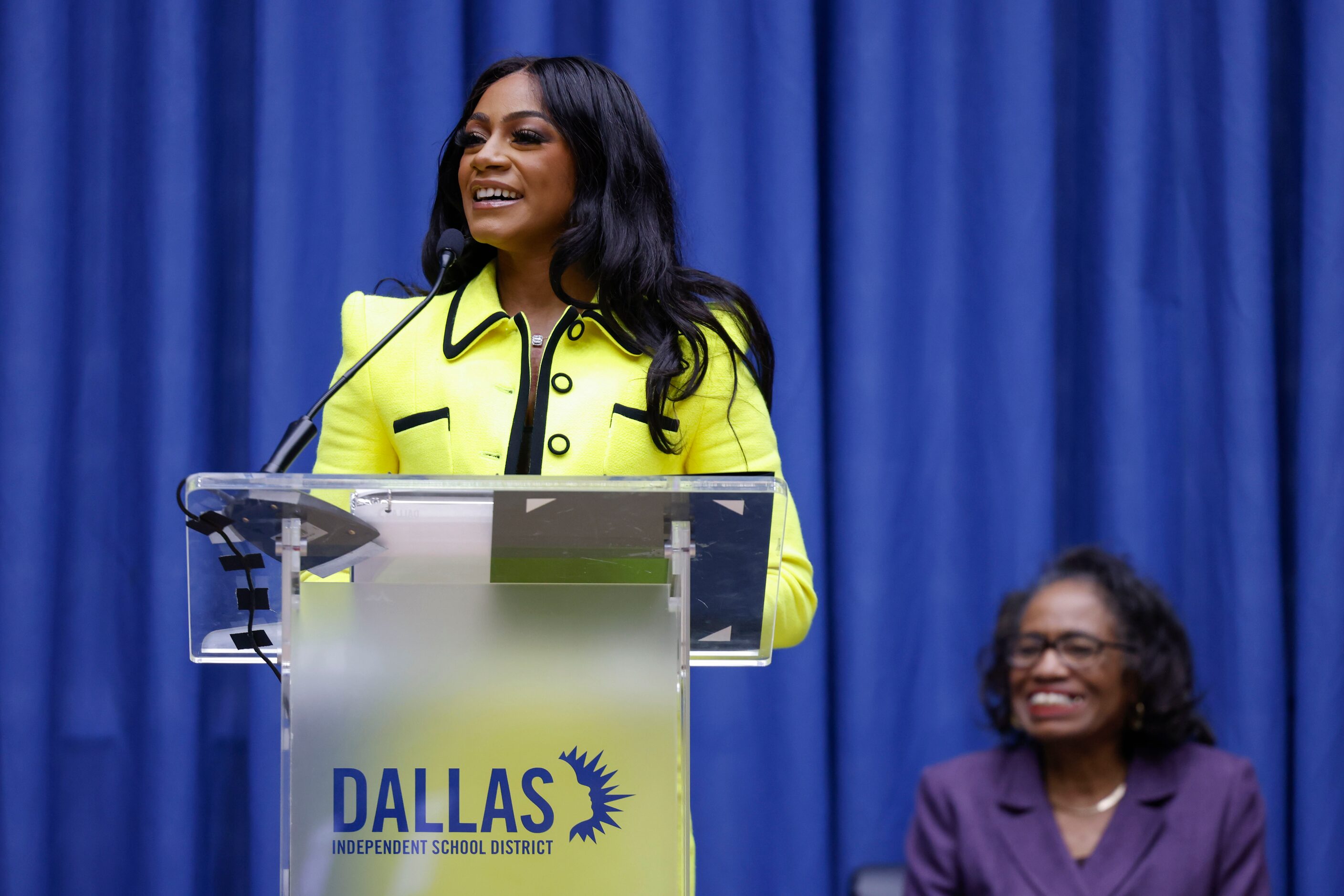 100 meters world champion Sha'Carri Richardson, (left), speaks as DISD trustee Joyce Foreman...