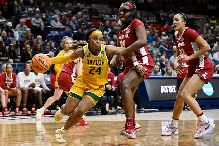 Baylor's Sarah Andrews (24) dribbles around Alabama's Jada Rice (31) in the first half of a...