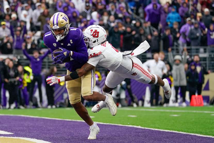 FILE - Washington wide receiver Rome Odunze (1) makes a catch for a touchdown against Utah...