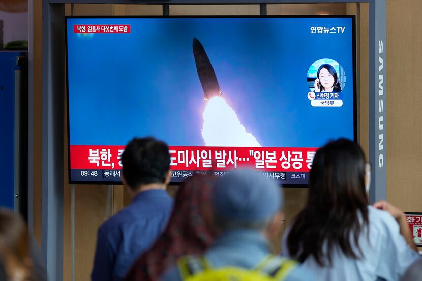 A TV screen showing a news program reporting about North Korea's missile launch with file...