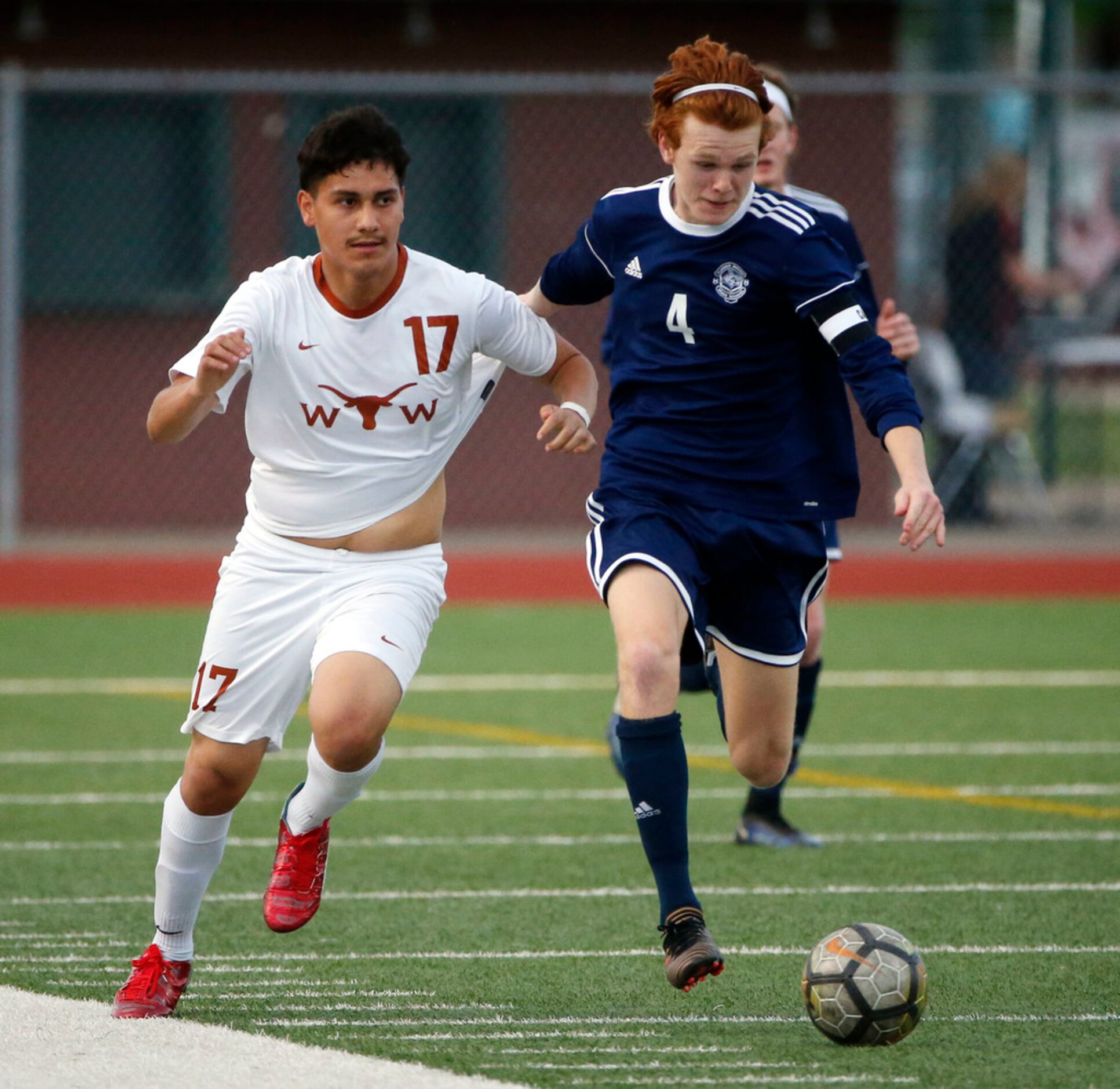 W.T. White's Jorge Rodriguez  (17) and Flower Mound's Jackson Captain (4) chase the ball...