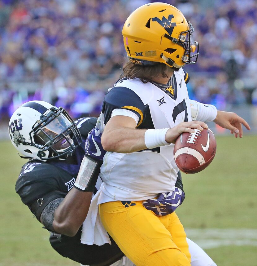 TCU defensive end Ben Banogu (15) pressures West Virginia quarterback Will Grier (7) in the...