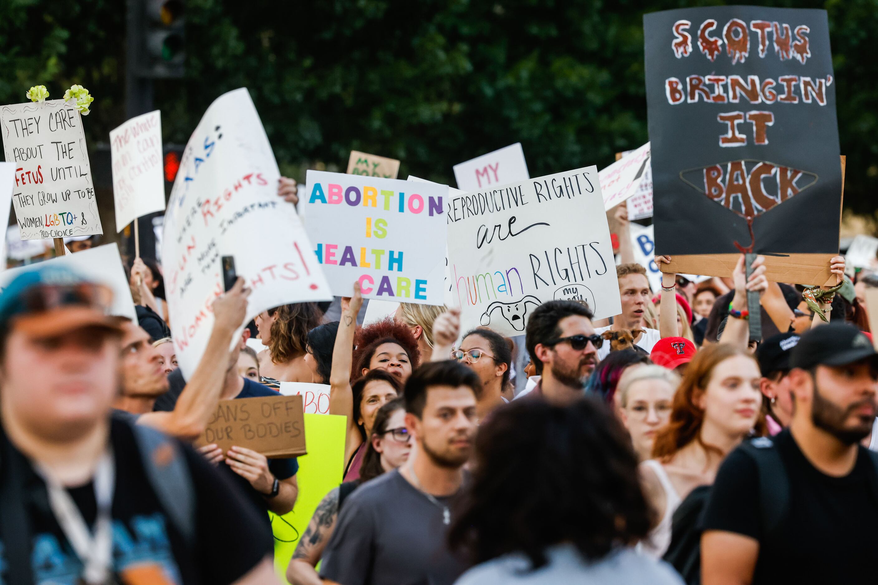 A group of demonstrators march from the Civic Garden along Main St in downtown Dallas on...