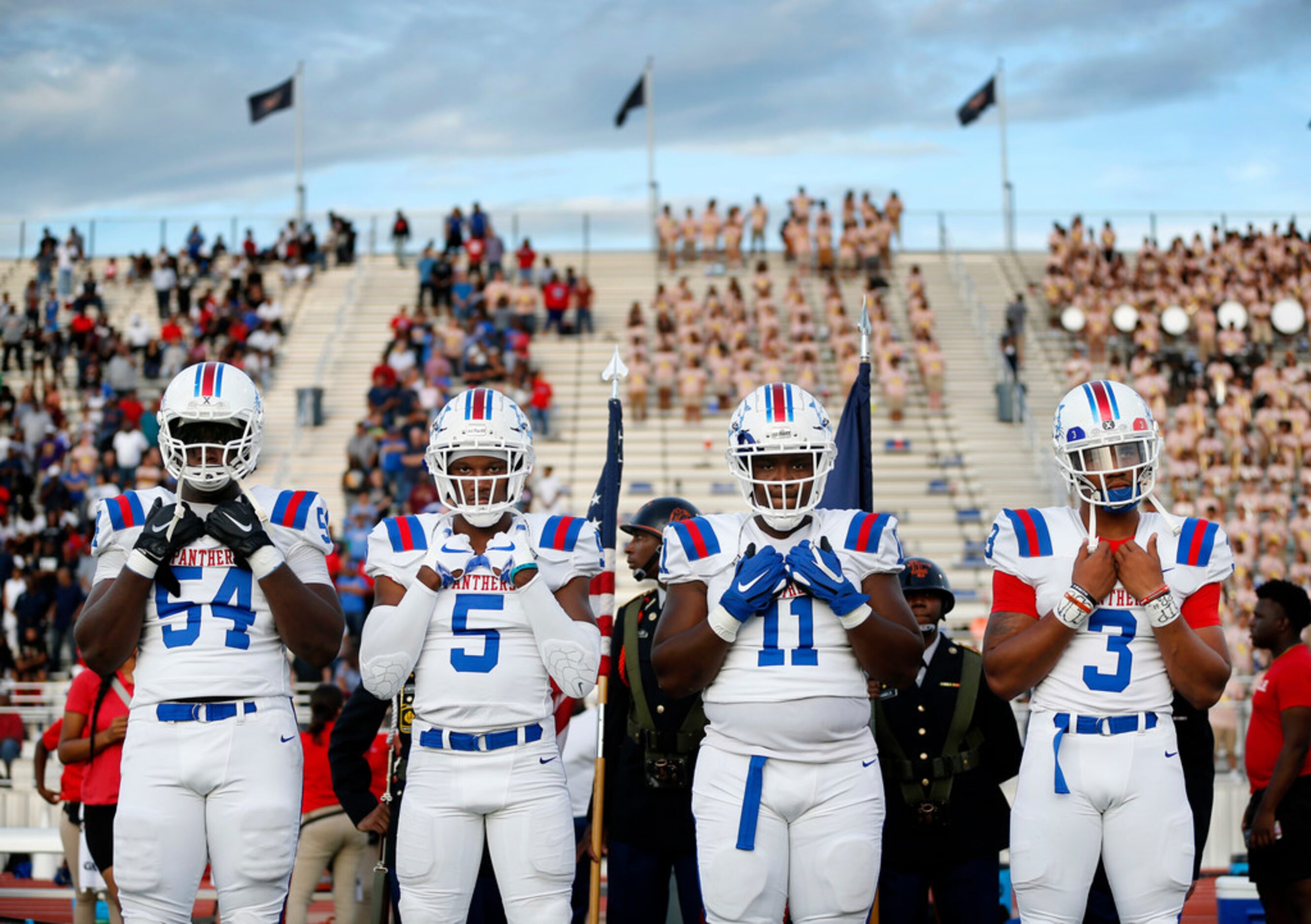 Duncanville team captains Savion Byrd (54), Christopher Thompson (5), James Mitchell (11)...