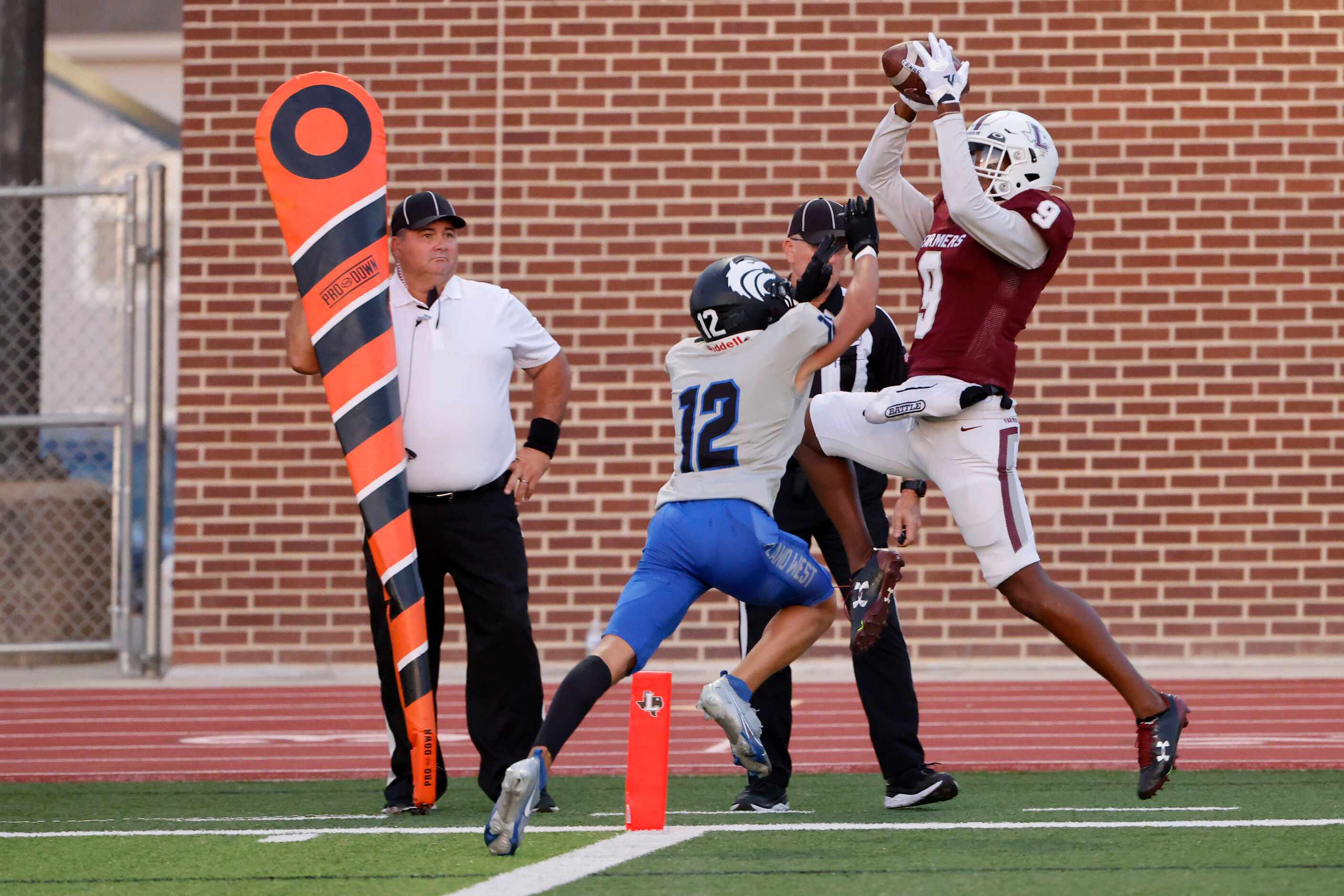 Lewisville receiver Armani Winfield (9) catches a touchdown in front of Plano West defender...